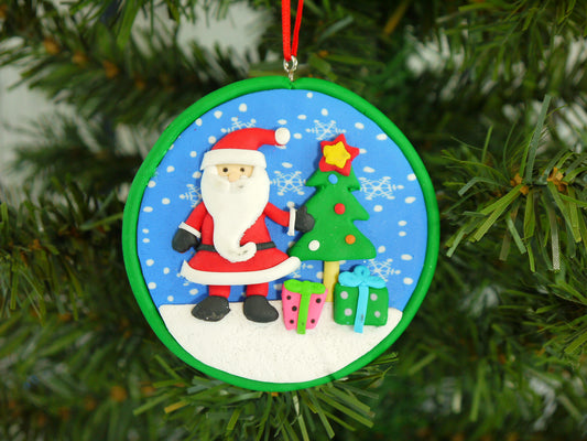 Close up of the detailed Santa, Christmas tree, and presents set inside the polyclay medallion.