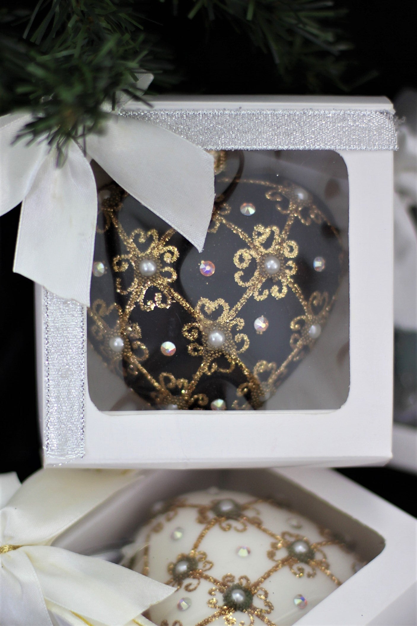 The 11 cm black heart bauble presented in a premium white gift box with satin bow.