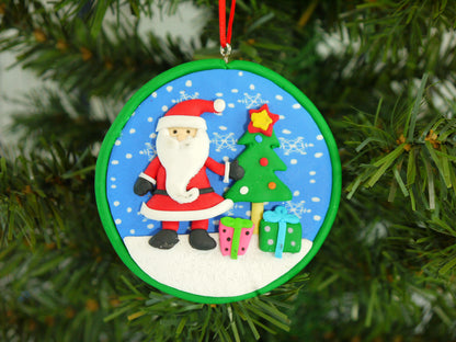 Close up of the detailed Santa, Christmas tree, and presents set inside the polyclay medallion.