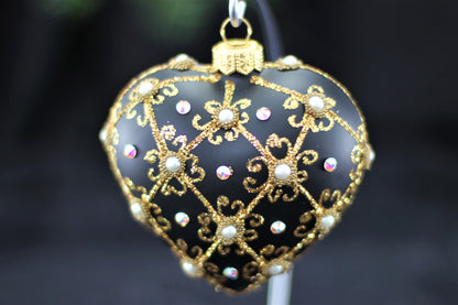 Close up of filigree pattern and genuine Swarovski crystal detail on black heart ornament.